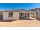 Home's backyard featuring covered patio, block fence and space for landscaping at 18418 W Monte Lindo Ln, Surprise, AZ 85387