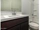 A well-lit bathroom with a vanity, mirror, and tiled shower at 18418 W Monte Lindo Ln, Surprise, AZ 85387