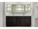 Bright bathroom featuring dual sinks, vanity and tile floor at 18418 W Monte Lindo Ln, Surprise, AZ 85387