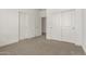 Neutral-toned bedroom with large closet and views of hall at 18418 W Monte Lindo Ln, Surprise, AZ 85387