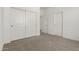 Neutral-toned bedroom with large closet and views of hall at 18418 W Monte Lindo Ln, Surprise, AZ 85387