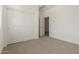 Bright bedroom with large closet and neutral carpet flooring at 18418 W Monte Lindo Ln, Surprise, AZ 85387