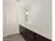 The butlers pantry features white countertop and dark wood cabinets at 18418 W Monte Lindo Ln, Surprise, AZ 85387