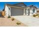Lovely single-story home featuring a two-car garage and desert landscaping for low maintenance at 18418 W Monte Lindo Ln, Surprise, AZ 85387