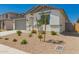 Inviting single-story home with a two-car garage and desert landscaping for a clean aesthetic at 18418 W Monte Lindo Ln, Surprise, AZ 85387