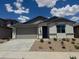 Charming single-story home featuring a two-car garage, desert landscaping, and a neutral color scheme at 18418 W Monte Lindo Ln, Surprise, AZ 85387