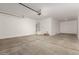Spacious, clean garage with concrete floors and a water heater at 18418 W Monte Lindo Ln, Surprise, AZ 85387