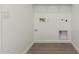 Bright laundry room with tile flooring and hookups at 18418 W Monte Lindo Ln, Surprise, AZ 85387