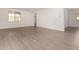 Spacious living room featuring neutral paint, tile floors and a bright, airy feel with lots of natural light at 18418 W Monte Lindo Ln, Surprise, AZ 85387