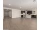 Open-concept layout with tile floors seamlessly connecting the living area and kitchen at 18418 W Monte Lindo Ln, Surprise, AZ 85387
