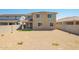 Wide backyard with partial grass and gravel, surrounded by a privacy wall at 18456 W Monte Lindo Ln, Surprise, AZ 85387