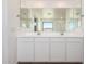 Bathroom with bright double vanity, ample storage, and large mirror for enhanced functionality at 18456 W Monte Lindo Ln, Surprise, AZ 85387