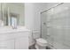 Bathroom features white vanity, tile floor and glass-enclosed shower at 18456 W Monte Lindo Ln, Surprise, AZ 85387