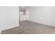Upstairs bedroom with neutral carpet and bright white walls at 18456 W Monte Lindo Ln, Surprise, AZ 85387