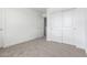 Carpeted bedroom showcasing closet space and bright white walls at 18456 W Monte Lindo Ln, Surprise, AZ 85387