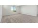 Bright bedroom featuring a carpeted floor, a window, and white walls at 18456 W Monte Lindo Ln, Surprise, AZ 85387