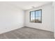 Light-filled bedroom featuring carpet, a window, and neutral walls at 18456 W Monte Lindo Ln, Surprise, AZ 85387