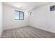 Bright carpeted bedroom features natural light from a window at 18456 W Monte Lindo Ln, Surprise, AZ 85387