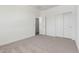 Spacious bedroom features neutral carpet and white walls at 18456 W Monte Lindo Ln, Surprise, AZ 85387