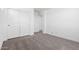 Bedroom with neutral carpet, closet with double doors, and bright white walls at 18456 W Monte Lindo Ln, Surprise, AZ 85387
