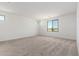 Bright, carpeted bedroom featuring ample natural light from several strategically placed windows at 18456 W Monte Lindo Ln, Surprise, AZ 85387