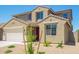 Welcoming two-story home with a practical two car garage, set in a low-maintenance desert landscape at 18456 W Monte Lindo Ln, Surprise, AZ 85387