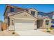 Attractive two-story home with a two-car garage and an easy-care desert-style landscaped front yard at 18456 W Monte Lindo Ln, Surprise, AZ 85387