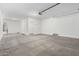 Open two car garage with concrete floor; ready for customization and storage solutions at 18456 W Monte Lindo Ln, Surprise, AZ 85387