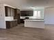 Modern kitchen features dark cabinetry, stainless appliances, white quartz countertops, and a large island at 18456 W Monte Lindo Ln, Surprise, AZ 85387