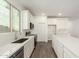 Modern kitchen with stainless steel appliances, quartz countertops and white herringbone backsplash at 18456 W Monte Lindo Ln, Surprise, AZ 85387