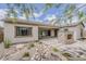 Rear view of the home showcasing desert landscaping, patio and stone fireplace at 18624 W Cathedral Rock Dr, Goodyear, AZ 85338