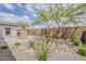 Backyard with stone fireplace, desert landscaping, and block wall at 18624 W Cathedral Rock Dr, Goodyear, AZ 85338