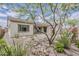 View of the home's backyard showcasing desert landscaping and a stone fireplace at 18624 W Cathedral Rock Dr, Goodyear, AZ 85338