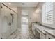 Elegant bathroom with a glass shower, marble floors, and double sinks at 18624 W Cathedral Rock Dr, Goodyear, AZ 85338