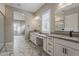 Bathroom showcases double vanity sinks, modern fixtures, and a view into living space at 18624 W Cathedral Rock Dr, Goodyear, AZ 85338