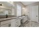 Spacious bathroom featuring double vanity sinks, modern fixtures, and marble floors at 18624 W Cathedral Rock Dr, Goodyear, AZ 85338