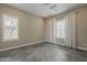 Bedroom with two windows and neutral walls and flooring at 18624 W Cathedral Rock Dr, Goodyear, AZ 85338