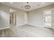 Expansive main bedroom features a neutral color palette, modern chandelier, and generous space at 18624 W Cathedral Rock Dr, Goodyear, AZ 85338