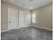 Bedroom has neutral walls, tiled flooring, and multiple doors at 18624 W Cathedral Rock Dr, Goodyear, AZ 85338