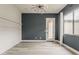 Stylish bedroom featuring white horizontal paneling, dark blue accent wall, and rear patio access at 18624 W Cathedral Rock Dr, Goodyear, AZ 85338