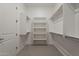 Spacious walk-in closet features custom shelving and rod system for storage at 18624 W Cathedral Rock Dr, Goodyear, AZ 85338