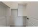 Walk-in closet features a variety of shelves and bars for organization at 18624 W Cathedral Rock Dr, Goodyear, AZ 85338