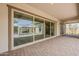 Covered patio with stone paved flooring and view of an outdoor fireplace and landscaping at 18624 W Cathedral Rock Dr, Goodyear, AZ 85338