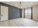Dining room with wood-look laminate flooring, dark blue accent wall and a decorative chandelier at 18624 W Cathedral Rock Dr, Goodyear, AZ 85338