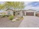 Attractive single-story home featuring a spacious 3-car garage and desert landscaping at 18624 W Cathedral Rock Dr, Goodyear, AZ 85338