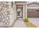 Home exterior featuring a stone-paved walkway leading to the front door and garage at 18624 W Cathedral Rock Dr, Goodyear, AZ 85338