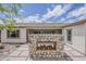 Rear of home showcasing stone fireplace feature on paver patio and desert landscaping at 18624 W Cathedral Rock Dr, Goodyear, AZ 85338