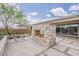 Backyard with stone fireplace, desert landscaping, and paver patio at 18624 W Cathedral Rock Dr, Goodyear, AZ 85338