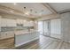 Modern kitchen features a center island, stainless steel appliances, and sliding glass doors to outdoor living space at 18624 W Cathedral Rock Dr, Goodyear, AZ 85338