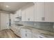Modern kitchen features sleek white cabinetry, gray subway tile backsplash and stainless steel appliances at 18624 W Cathedral Rock Dr, Goodyear, AZ 85338